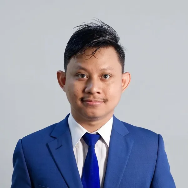 Ariff Azman in a blue suit, studio portrait